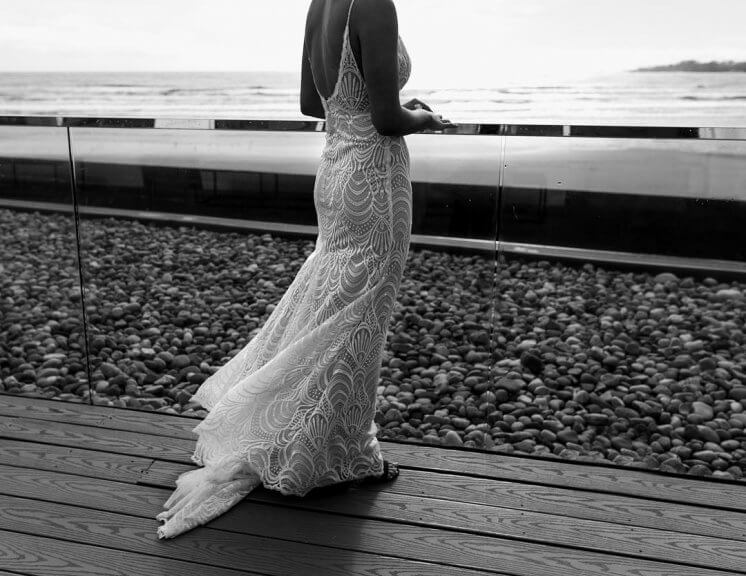 Newport Beach House-Eventide balcony-Bride with Lace Dress facing Ocean-booking your wedding venue_Madison Hope Photography